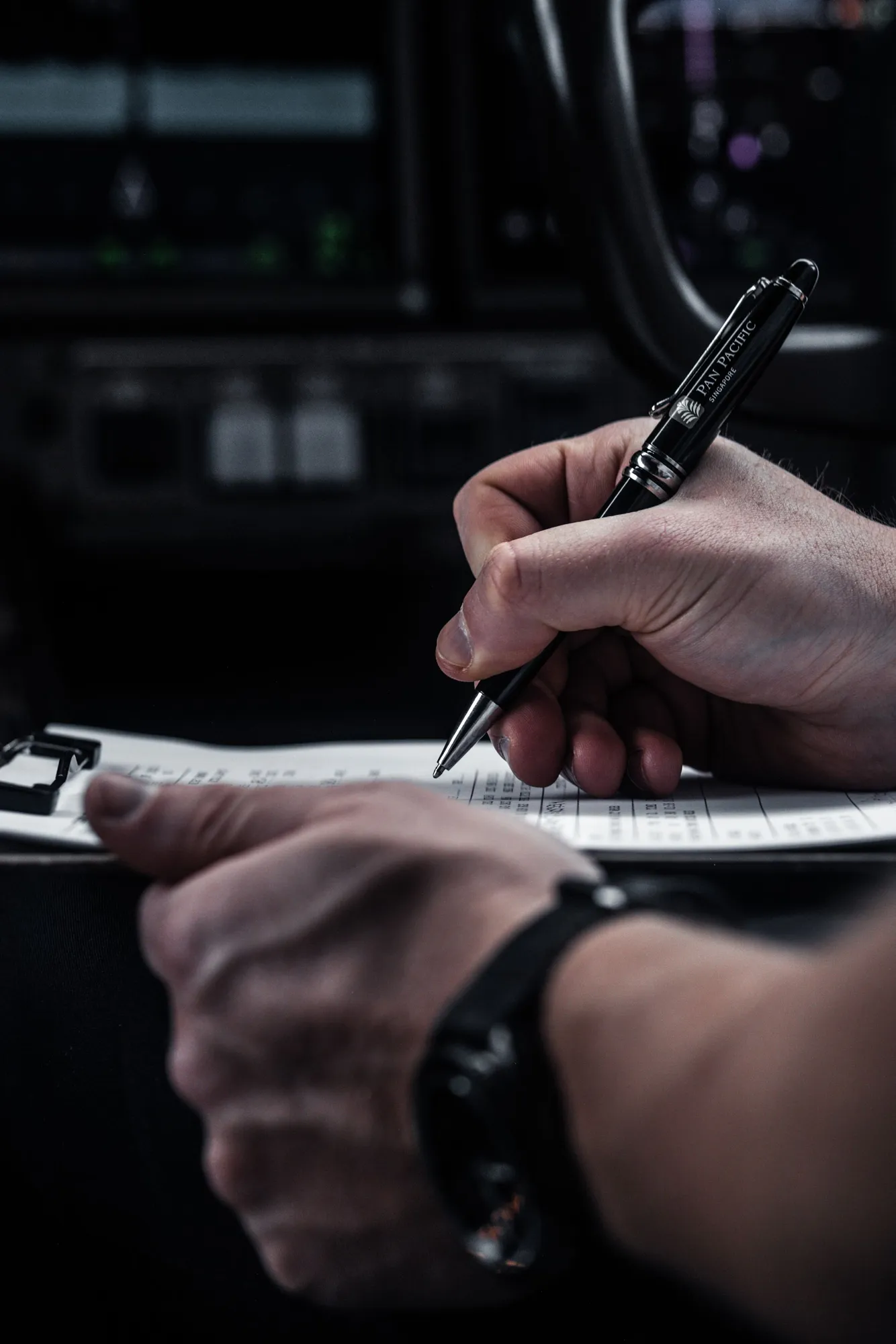 Pilot completing flight paperwork in a cockpit
