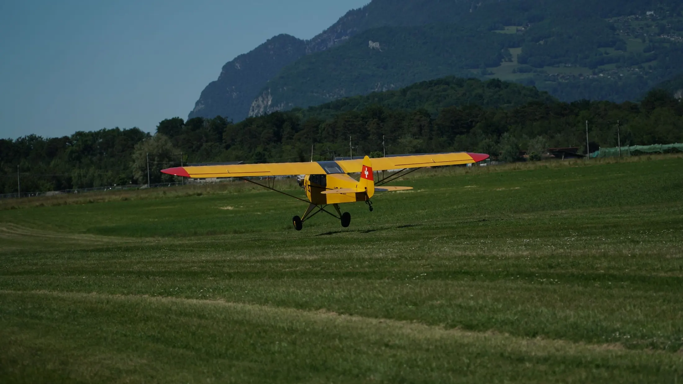 Yellow and blue light aircraft on a grass airfield in Germany