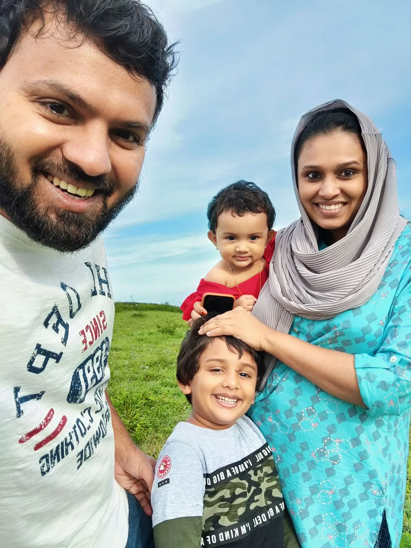 Family of four taking a selfie outdoors