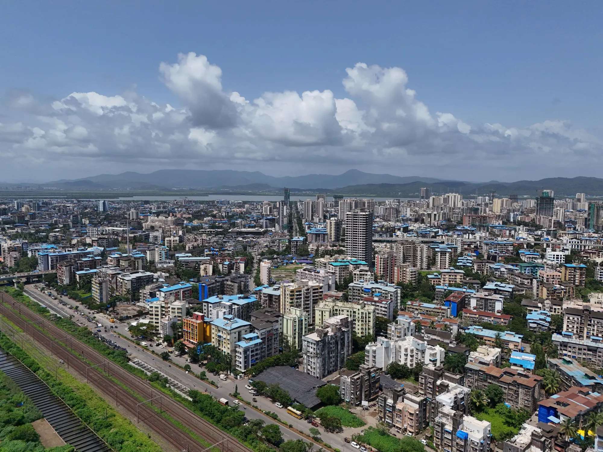 Aerial view of Mumbai high-rises under a blue sky