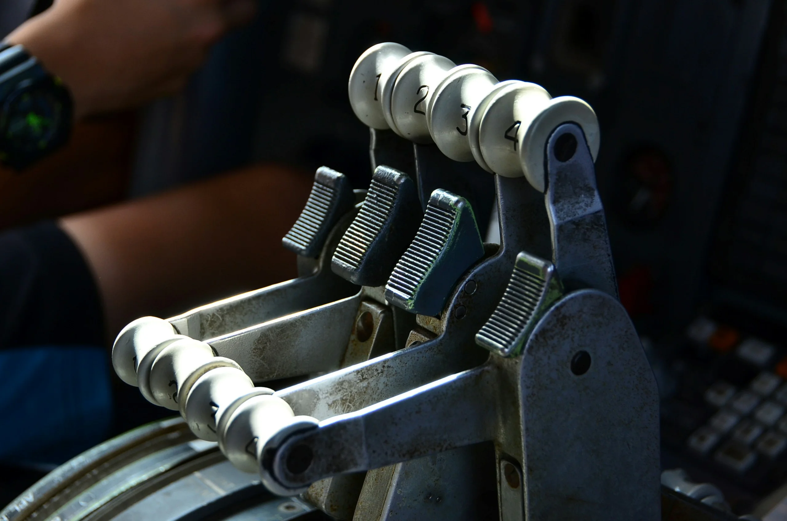 Pilot's hand on the thrust levers of an airliner flight deck