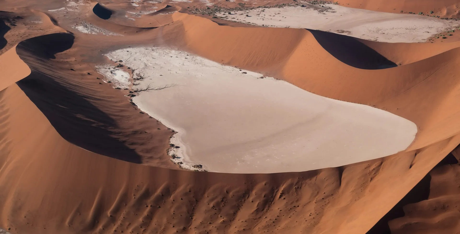 Red dunes around a white clay pan in the Namib Desert