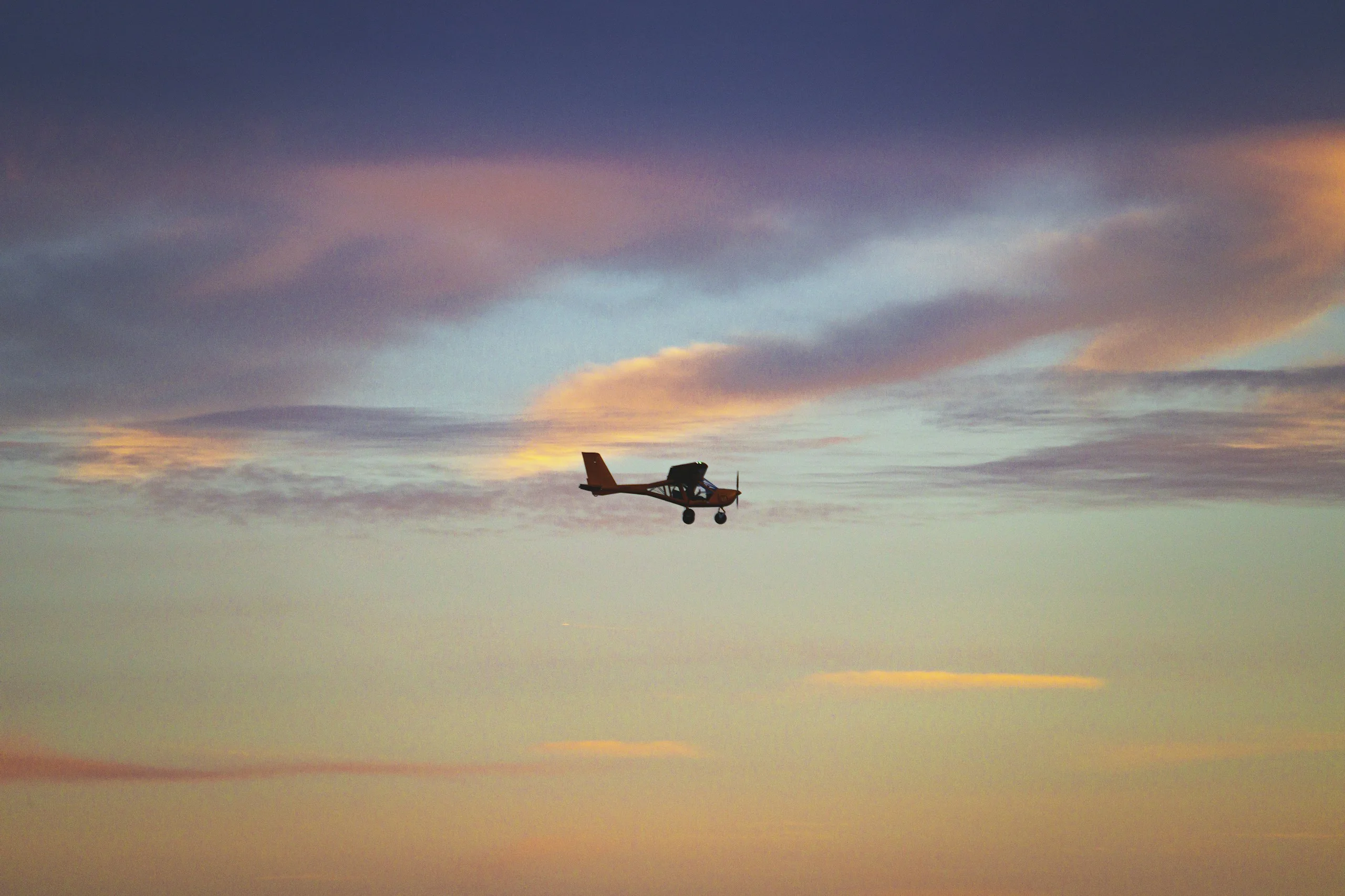 Light aircraft cockpit view at sunset