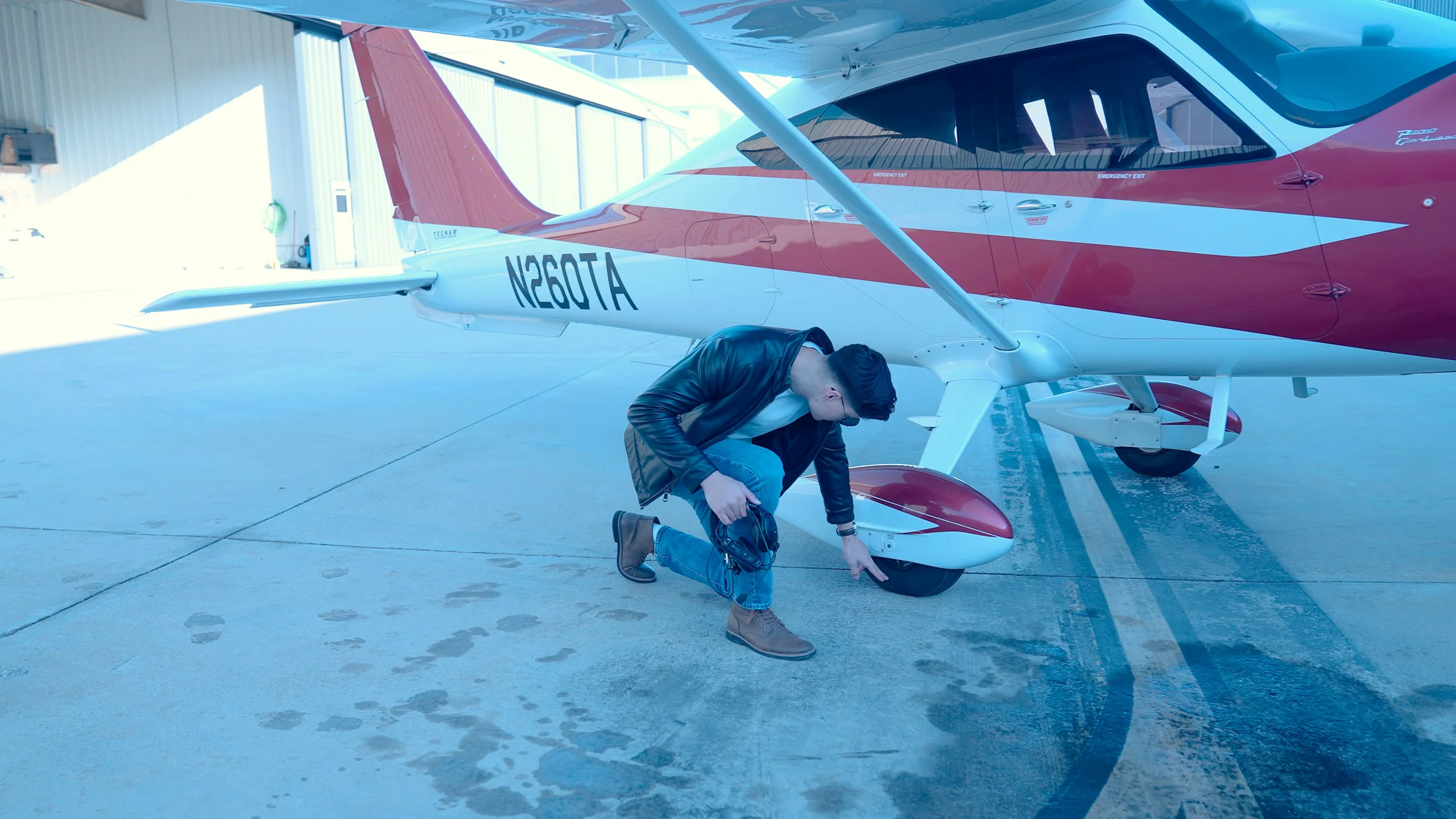 Person carrying out a pre-flight check on a light aircraft