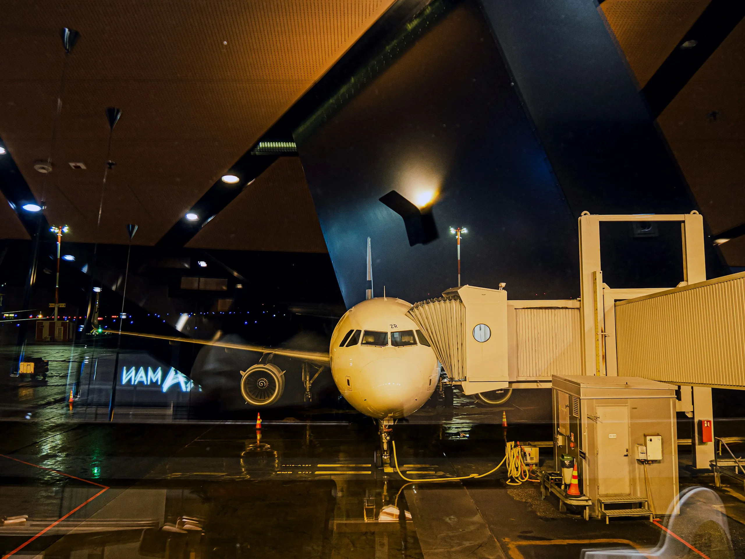 Airliner at a terminal gate at night