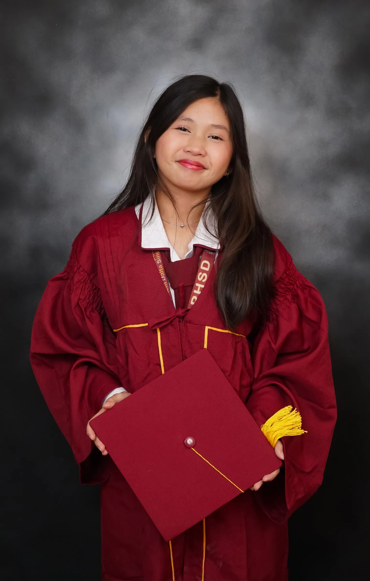 Graduate holding a graduation cap