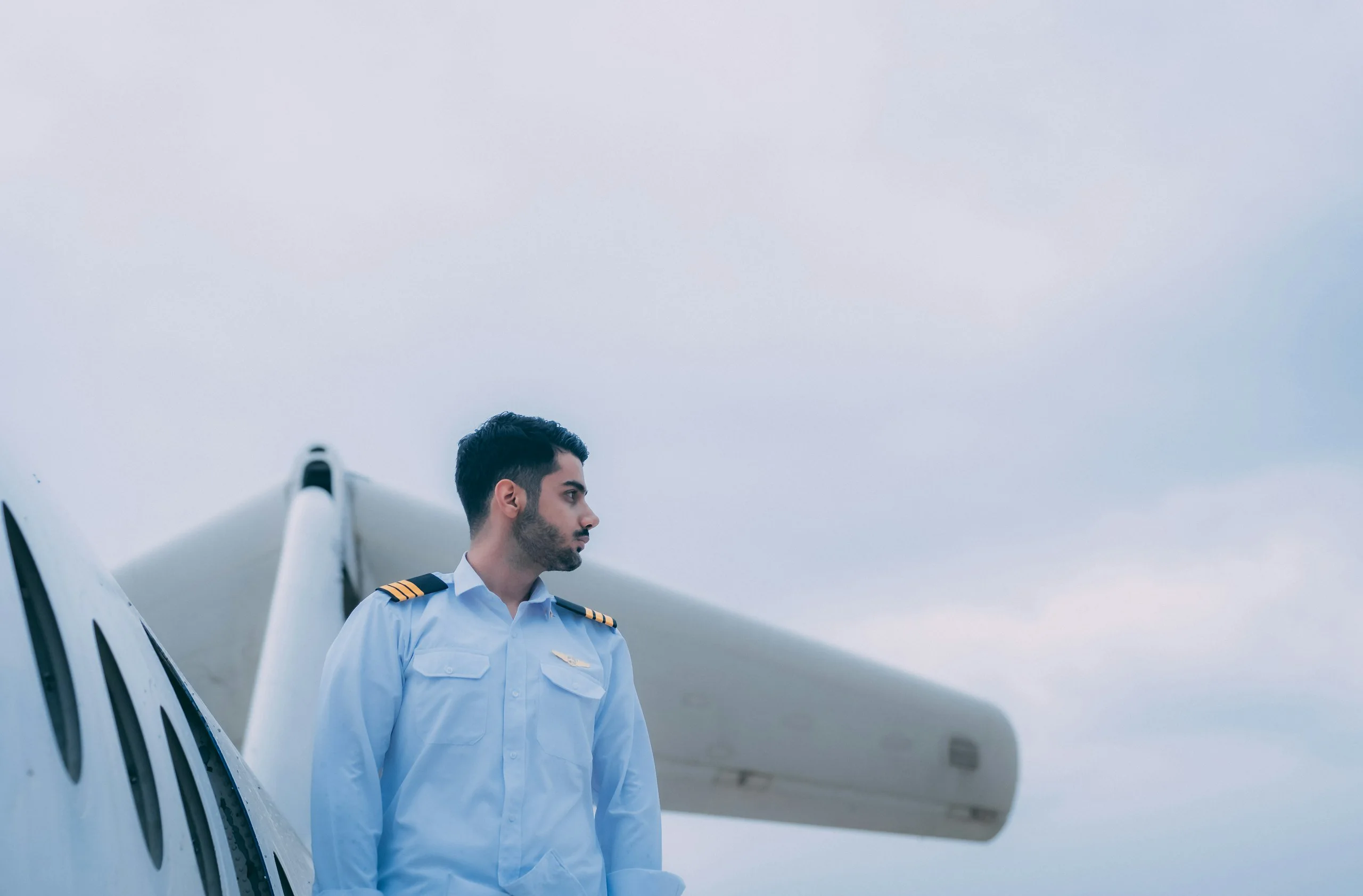 Pilot in uniform beside an aircraft