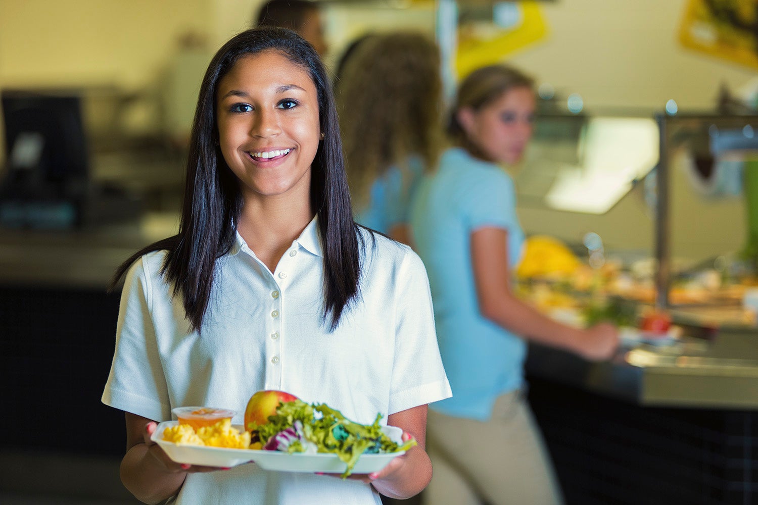 a woman holding a plate of food from student eats cape town